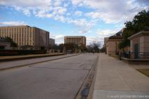 Looking down a walkway towards Congress Ave from the Texas State Capitol plaza.jpg