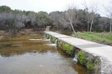Waters flowing under bridge at Sailmaster Falls Lakeway.jpg